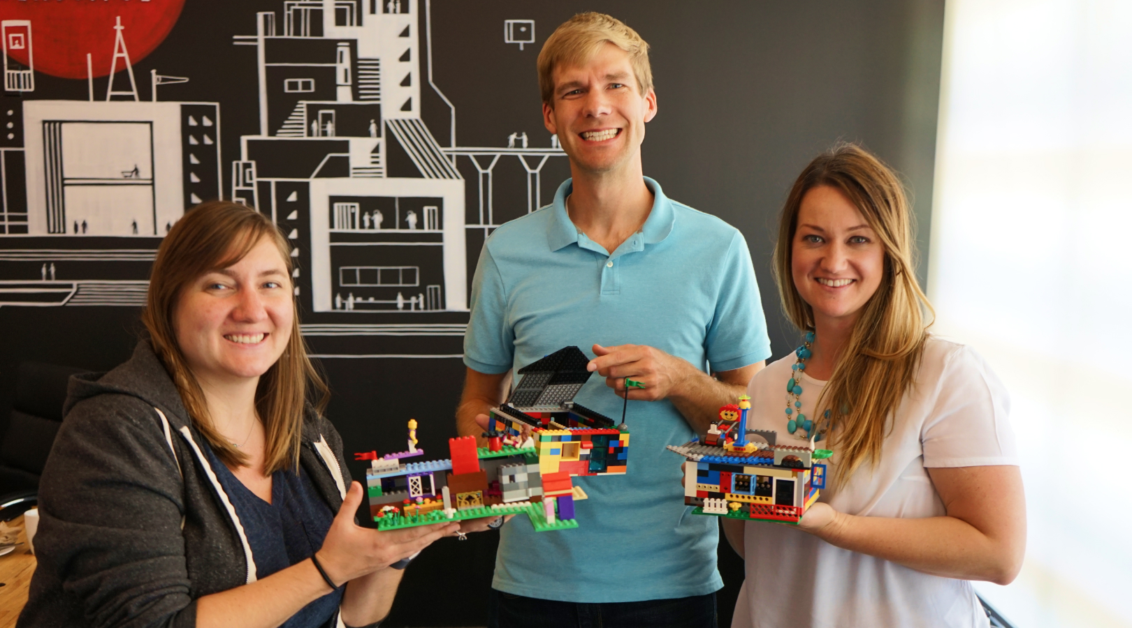 Photo of Aten employees showing the results of lego building group activity at a company summit