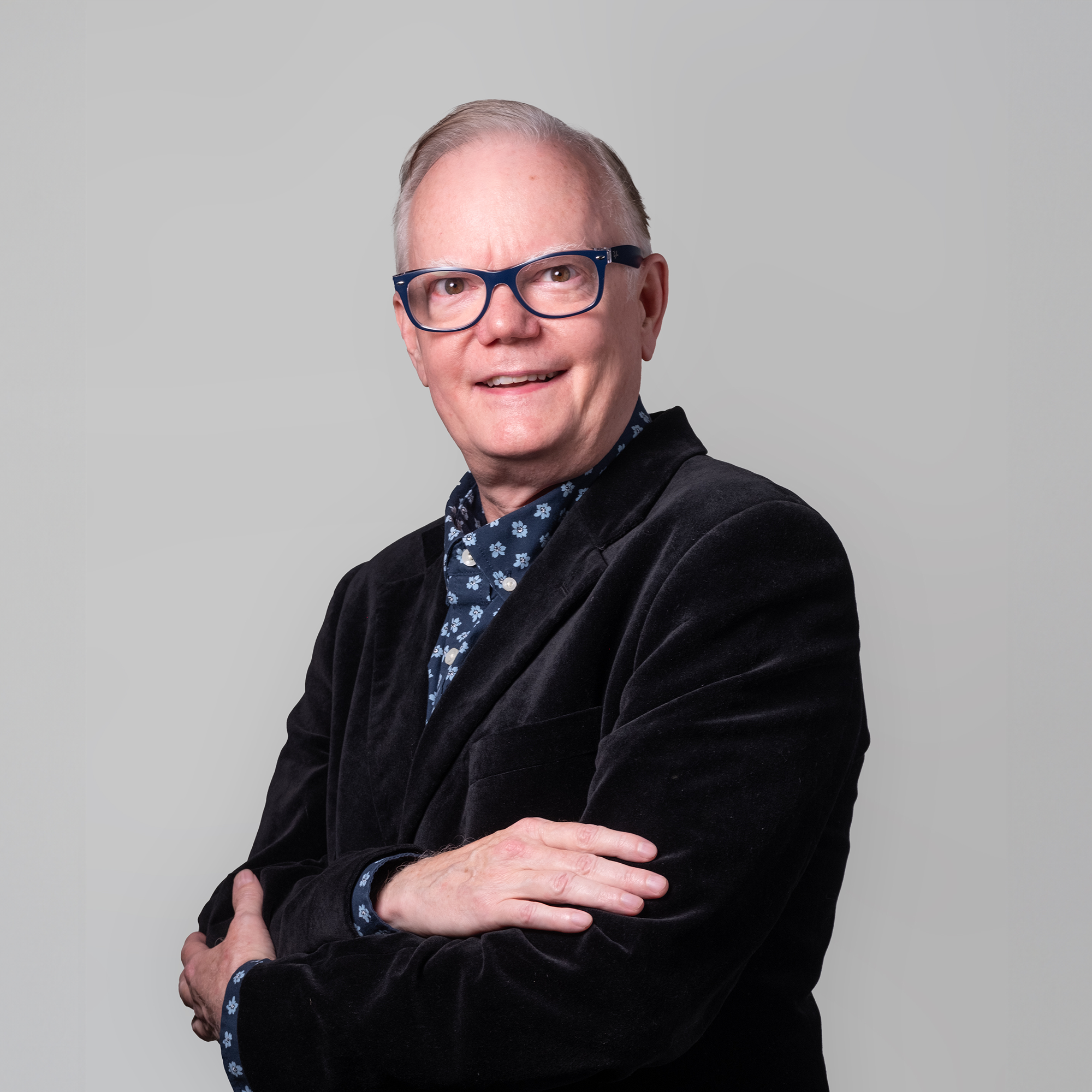 Headshot of Jon Betts on a gray background