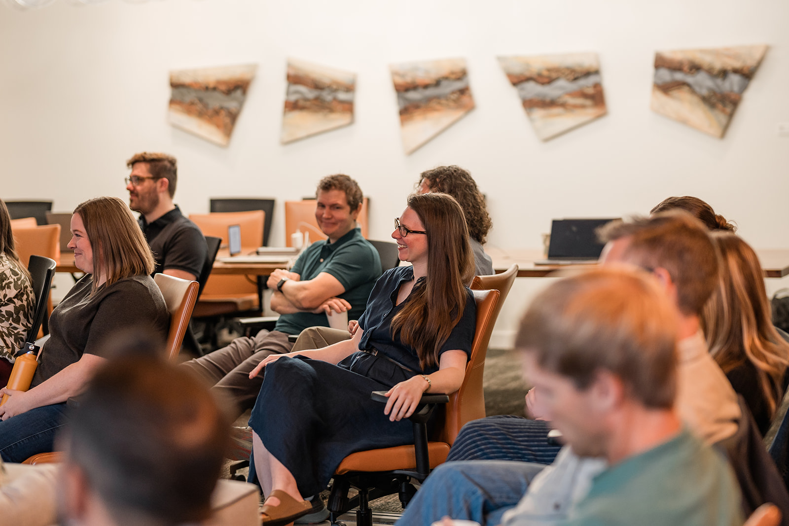 Aten staff listening to presentation while sitting down