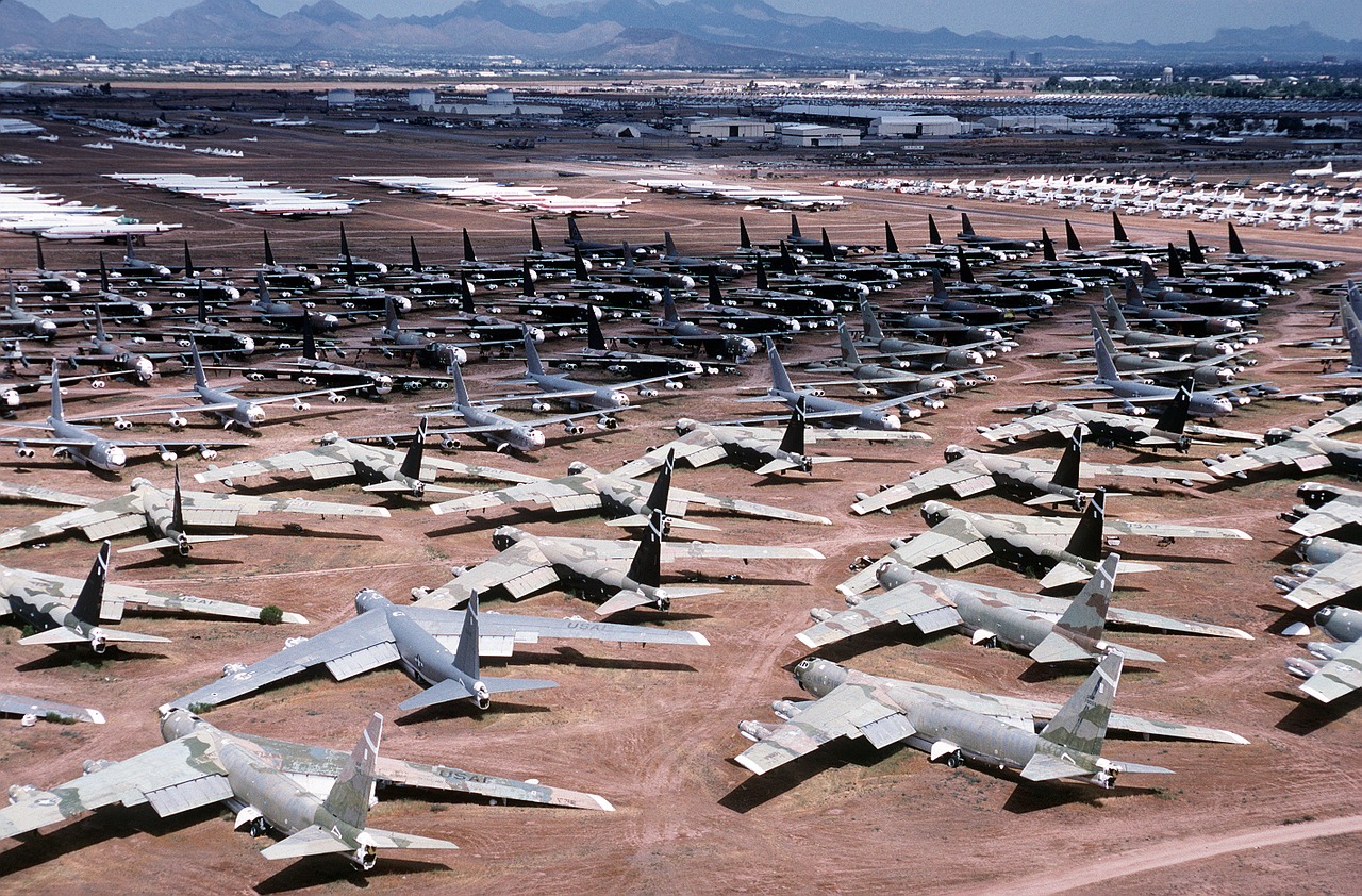 Many dilapidated planes in a desert.